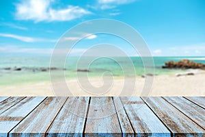 Wooden table ÃÂ top with blurred natural sea of tropical beach and blue sky, summer holiday background ideas for display